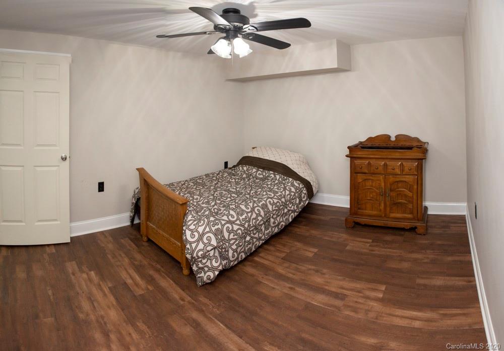 8585 Castor Road Salisbury, NC 28146 - Photo 15 of 39 a room with a bed and wooden floor