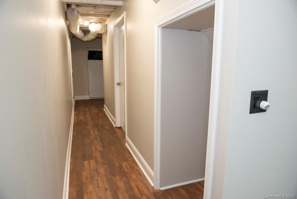 8585 Castor Road Salisbury, NC 28146 - Photo 22 of 39 a view of a hallway with wooden floor
