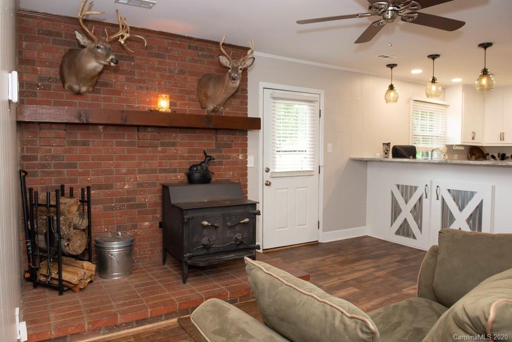 8585 Castor Road Salisbury, NC 28146 - Photo 26 of 39 a living room with furniture and a fireplace