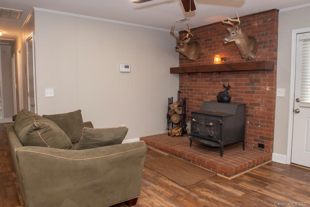 8585 Castor Road Salisbury, NC 28146 - Photo 27 of 39 a living room with furniture and a fireplace
