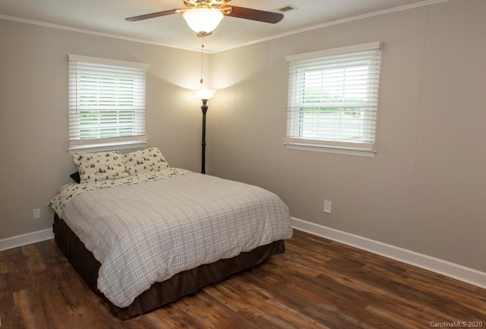 8585 Castor Road Salisbury, NC 28146 - Photo 33 of 39 a bedroom with a bed and a chandelier