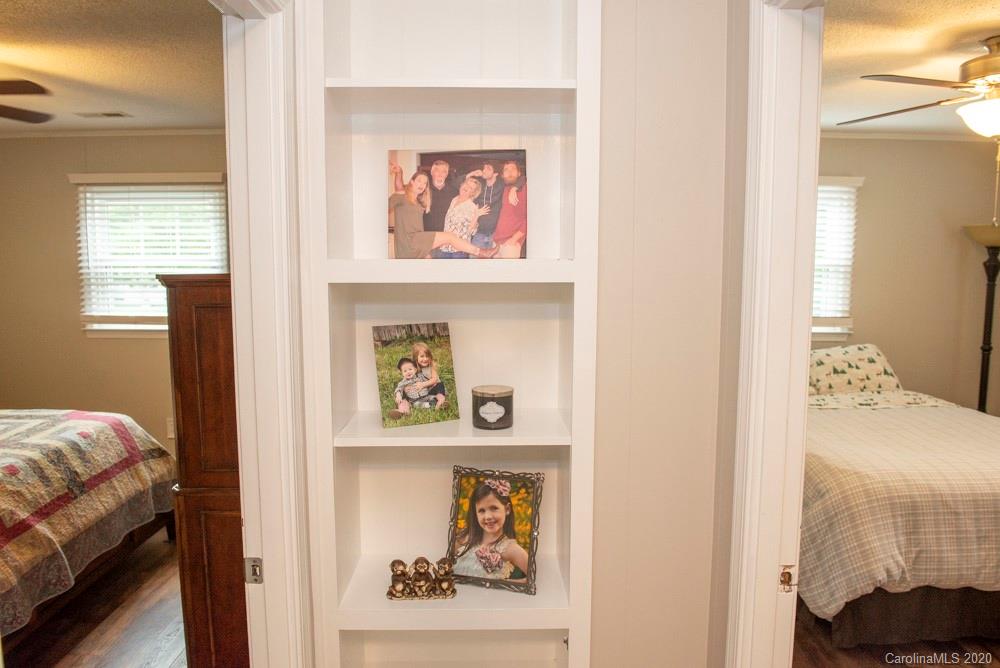 8585 Castor Road Salisbury, NC 28146 - Photo 34 of 39 a bedroom with a bed and a painting on the wall