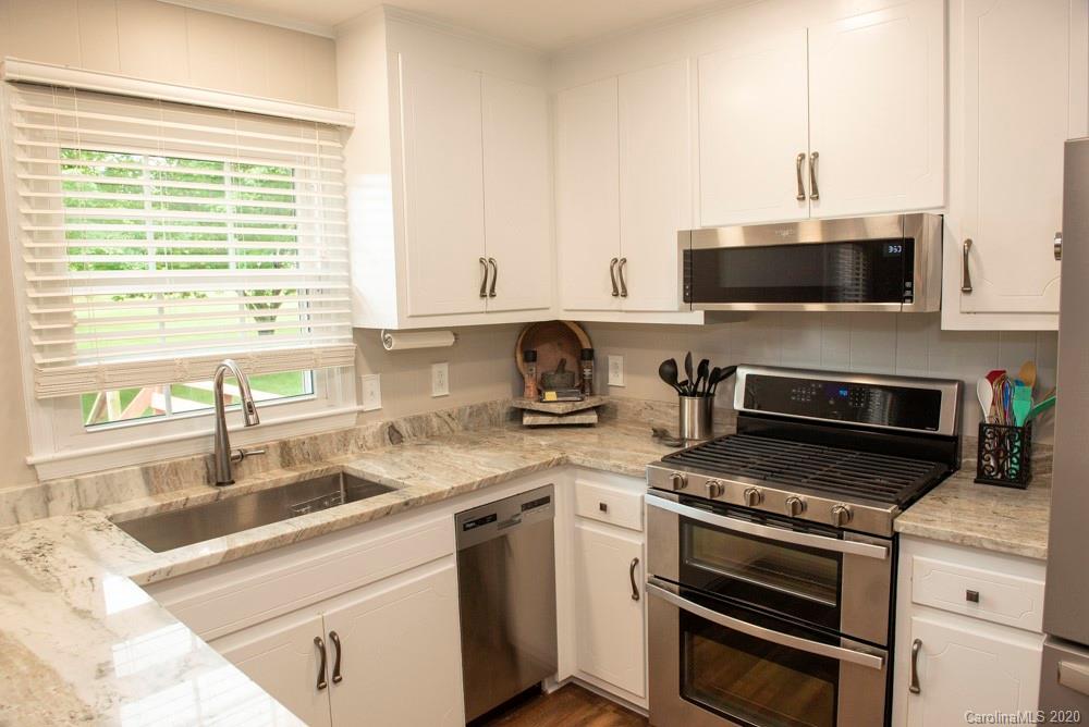 8585 Castor Road Salisbury, NC 28146 - Photo 6 of 39 a kitchen with stainless steel appliances a stove sink and microwave