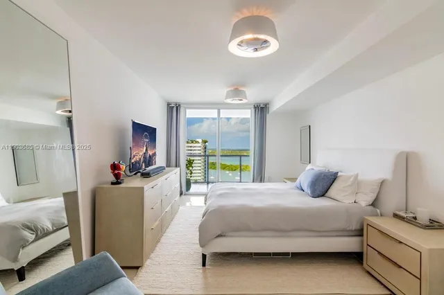 a bedroom with a bed couch and a window