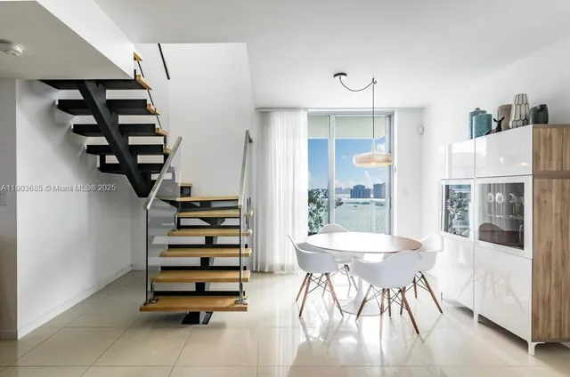 a view of a dining room with furniture and entryway