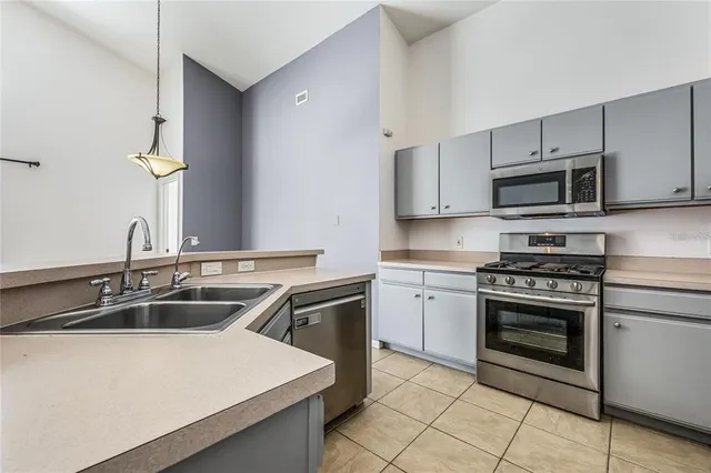 a kitchen with sink a microwave and stove