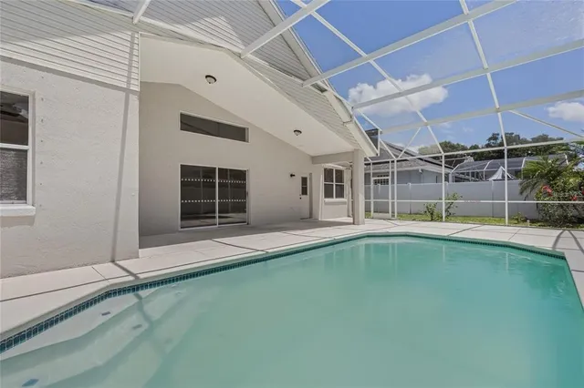 a view of a backyard with a swimming pool