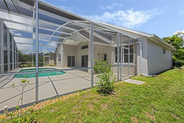 a view of a house with a backyard