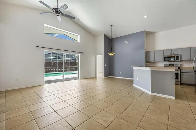 a view of a kitchen with cabinets and stainless steel appliances