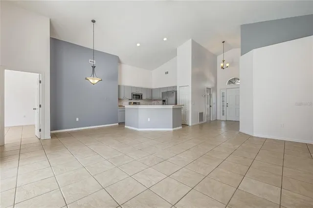 a view of a kitchen with a sink and a refrigerator