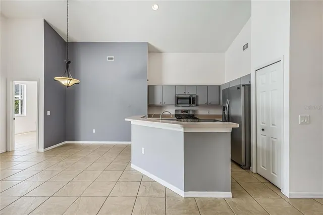 a kitchen with stainless steel appliances granite countertop a refrigerator and a stove