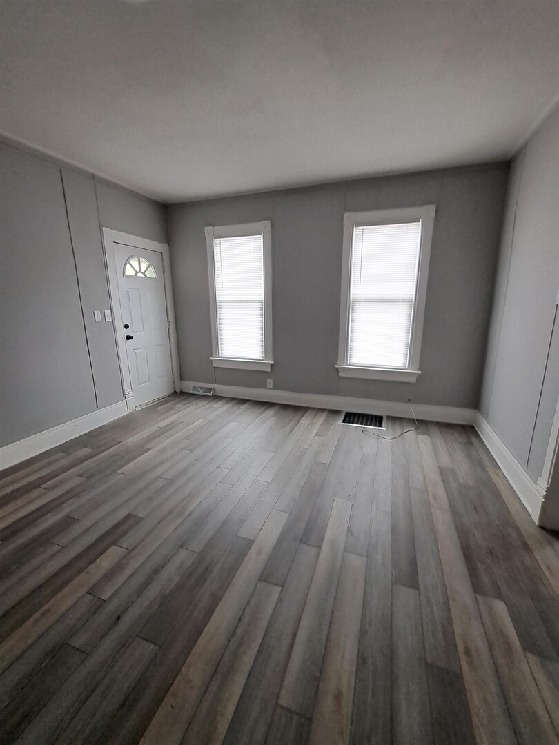 801 41st Street Rock Island, IL 61201 - Photo 6 of 8 an empty room with wooden floor and windows