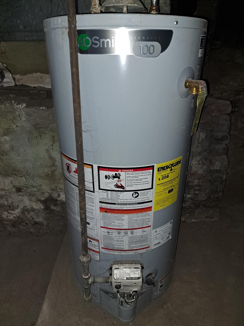 801 41st Street Rock Island, IL 61201 - Photo 7 of 8 a room with water heater and wooden cabinets