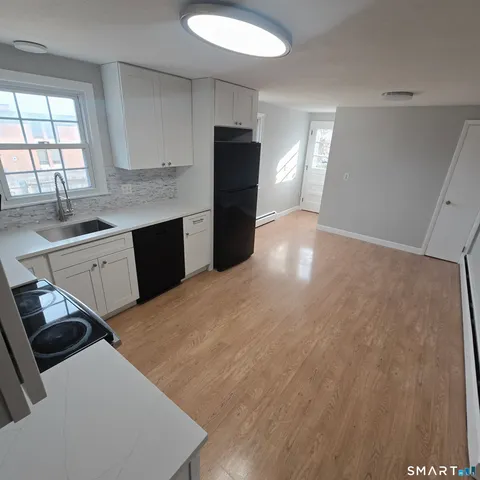 a kitchen with a refrigerator and a sink
