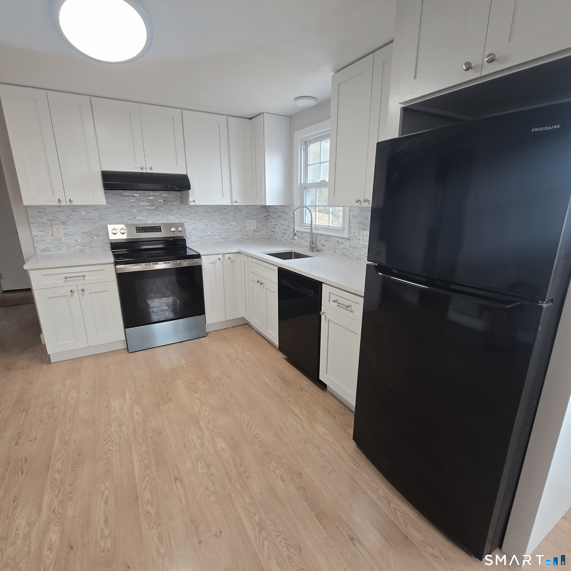 26 Tifton Road Wethersfield, CT 06109 - Photo 2 of 26 a kitchen with a refrigerator and a stove top oven