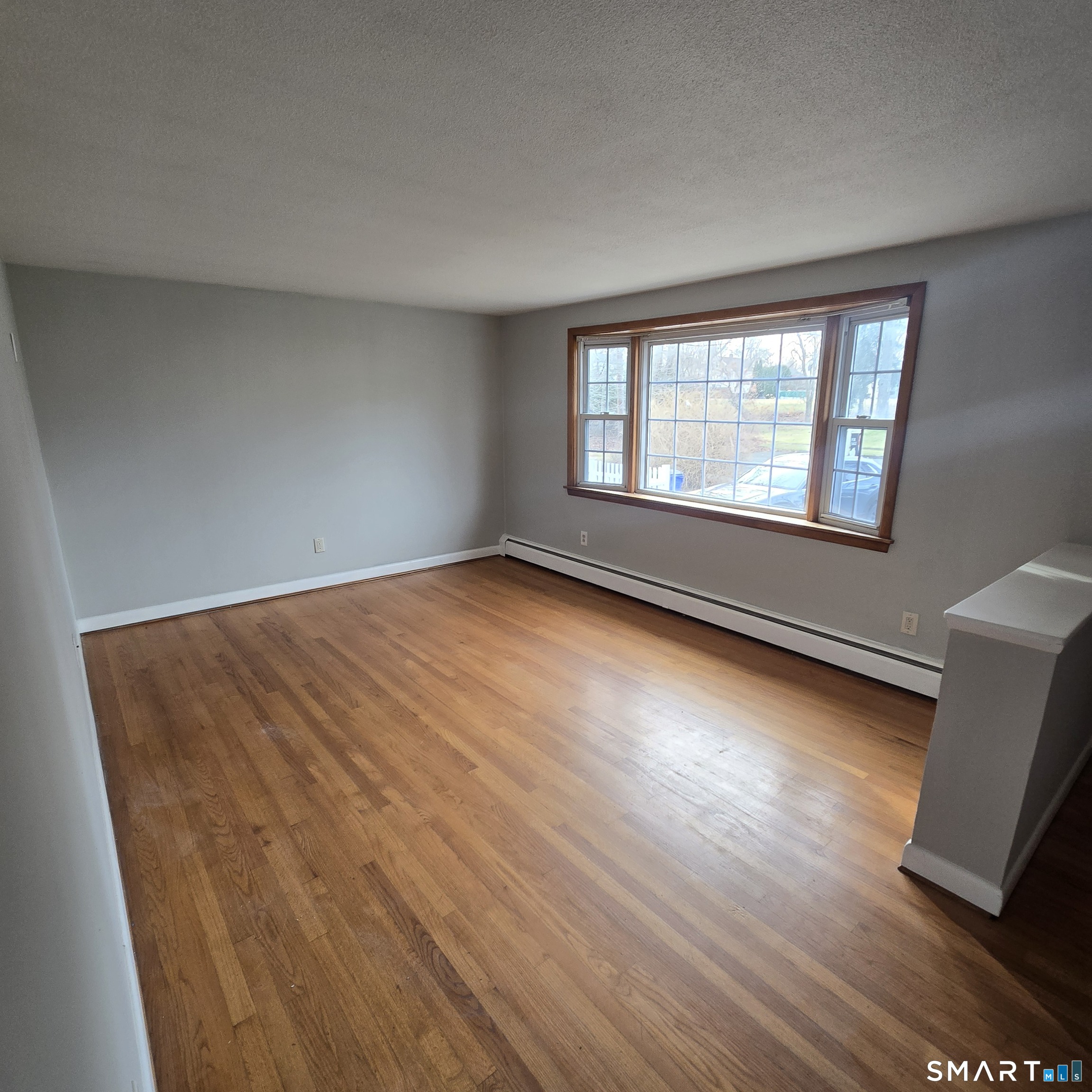 26 Tifton Road Wethersfield, CT 06109 - Photo 3 of 26 an empty room with wooden floor and windows