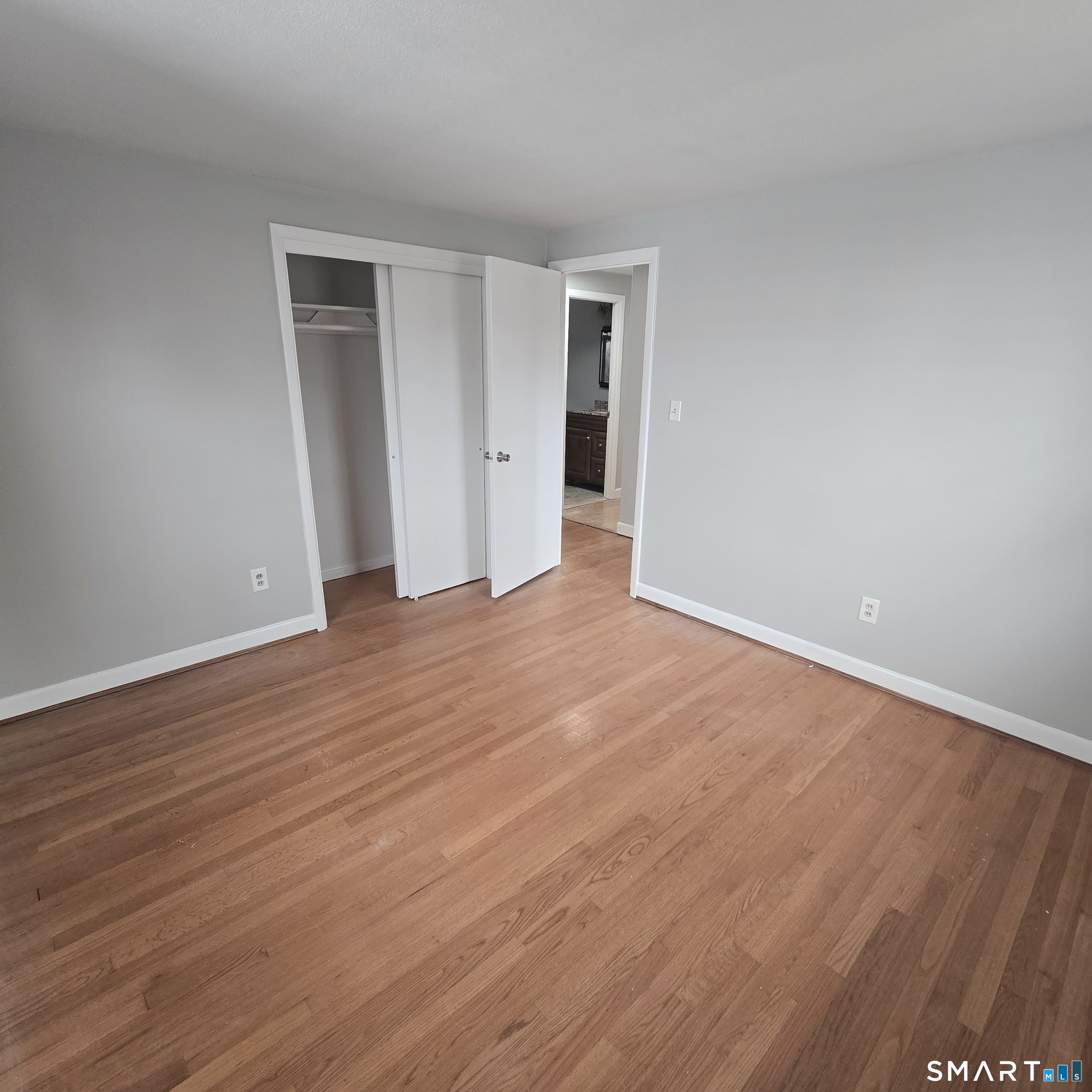 26 Tifton Road Wethersfield, CT 06109 - Photo 8 of 26 a view of an empty room with wooden floor and closet
