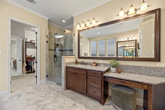 a spacious bathroom with a granite countertop sink and a mirror