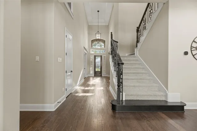 a view of entryway and hall with wooden floor