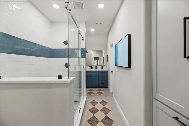 a spacious bathroom with a sink a mirror and a bathtub