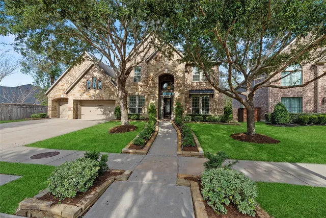 a view of house with yard and green space