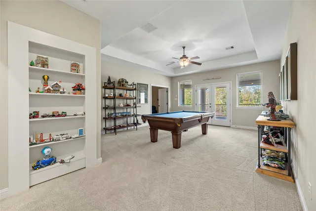 a living room with furniture and a book shelf