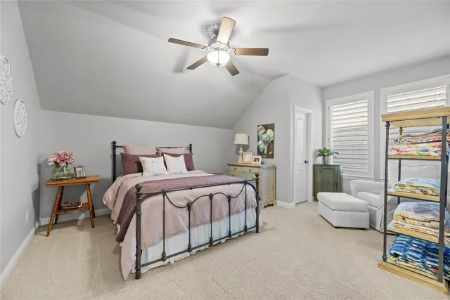 a spacious bedroom with a bed and a chandelier