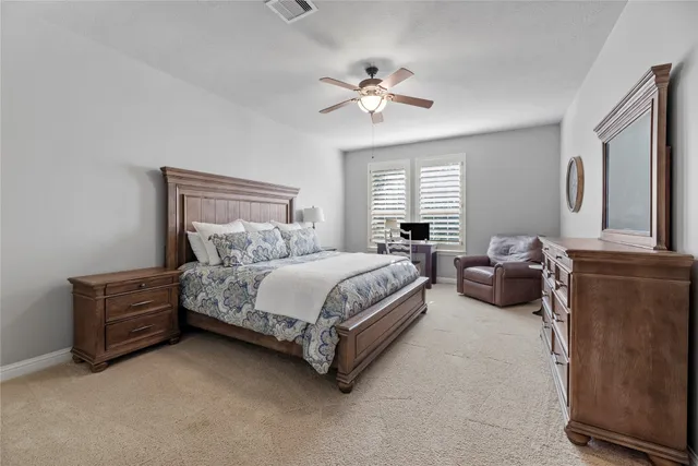a spacious bedroom with a bed and window