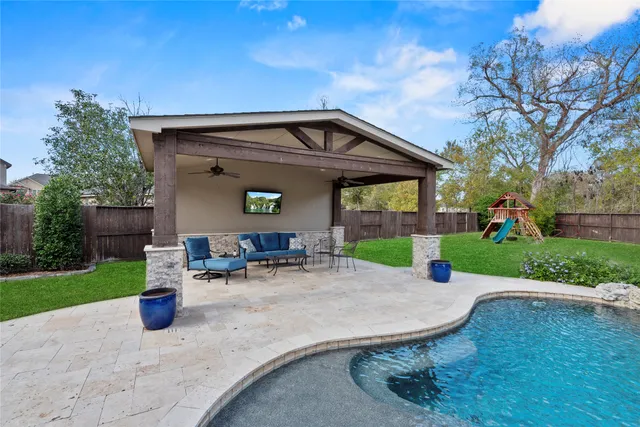 a view of a chair and table in backyard of the house