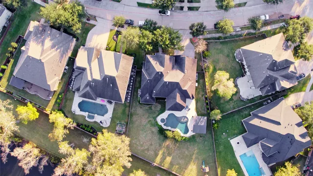 an aerial view of houses with yard