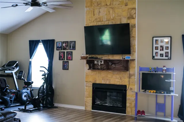 a living room with fireplace furniture and a flat screen tv