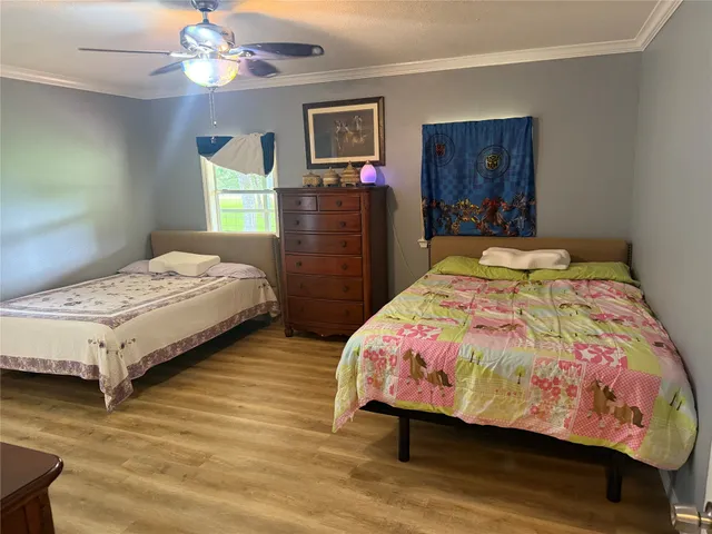 a bedroom with a bed and dresser with mirror
