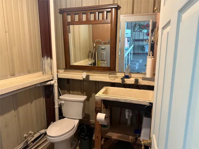 a bathroom with a toilet a sink and a window