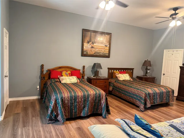 a bedroom with bed and a chandelier
