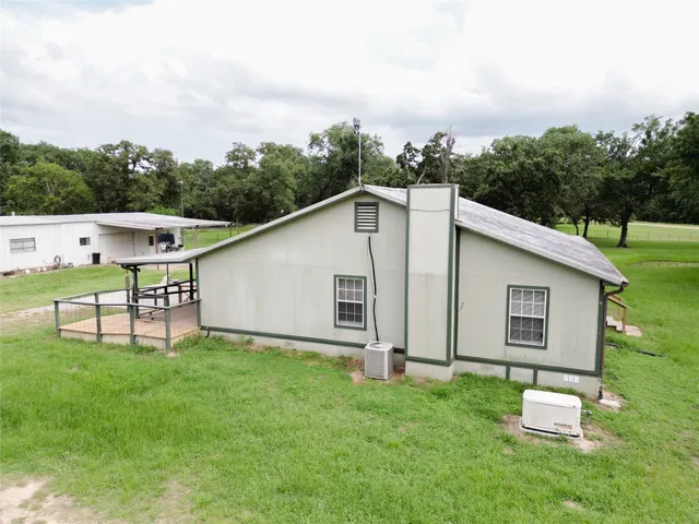 a backyard of a house with table and chairs