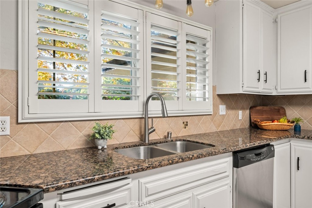 108 Estates Drive Chico, CA 95928 - Photo 13 of 45 a kitchen with granite countertop white cabinets and a sink