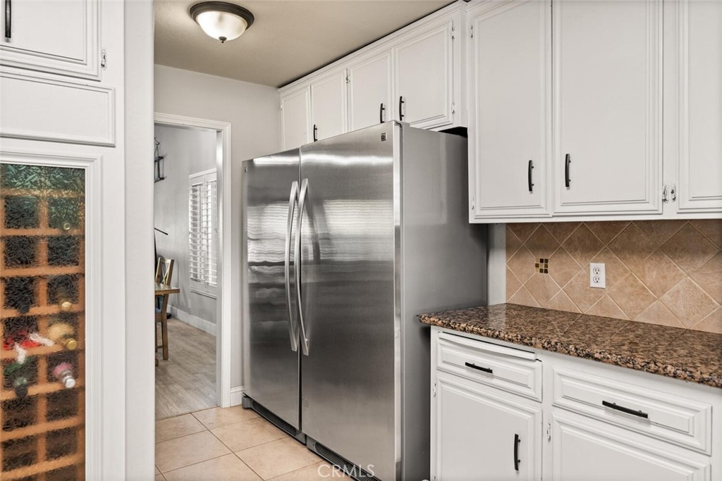 108 Estates Drive Chico, CA 95928 - Photo 15 of 45 a kitchen with granite countertop a refrigerator and cabinets