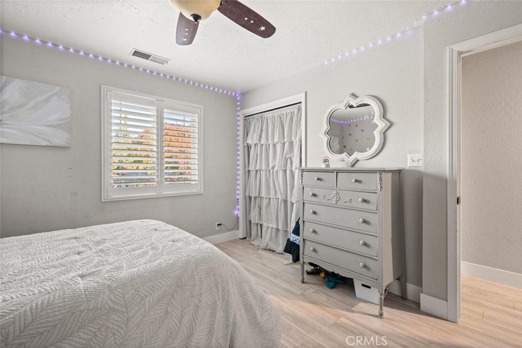 108 Estates Drive Chico, CA 95928 - Photo 27 of 45 a bedroom with a dresser and a chandelier