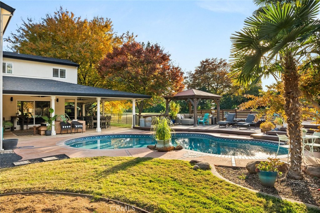 108 Estates Drive Chico, CA 95928 - Photo 35 of 45 a view of swimming pool with lawn chairs under an umbrella