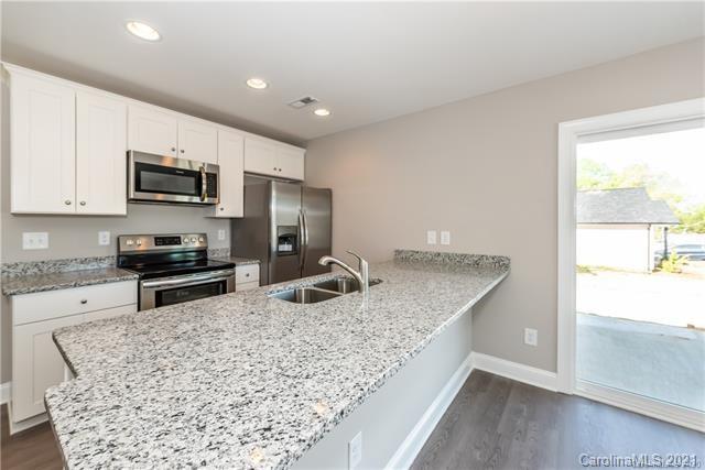 321 Salisbury Road Statesville, NC 28677 - Photo 2 of 13 a kitchen with stainless steel appliances granite countertop a sink stove and refrigerator
