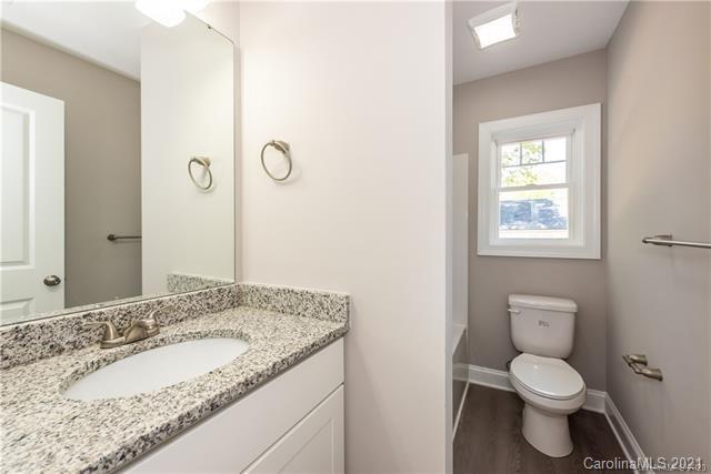 321 Salisbury Road Statesville, NC 28677 - Photo 12 of 13 a bathroom with a granite countertop toilet a sink and a mirror