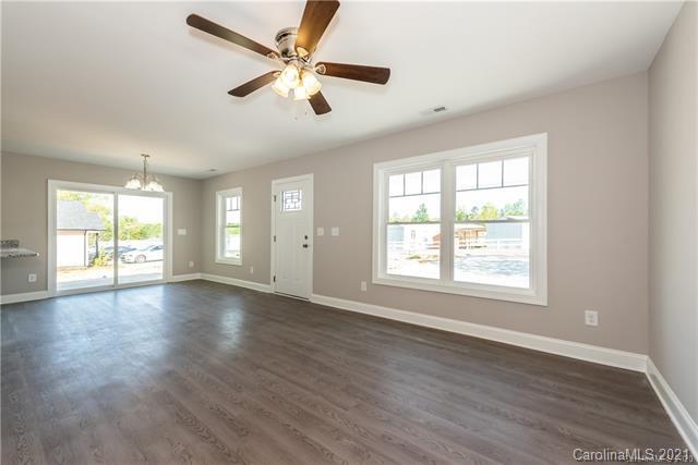 321 Salisbury Road Statesville, NC 28677 - Photo 6 of 13 a view of an empty room with wooden floor and a window