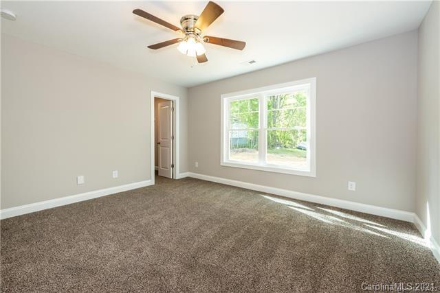 321 Salisbury Road Statesville, NC 28677 - Photo 7 of 13 an empty room with windows and fan