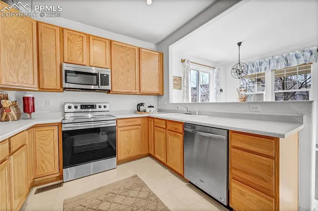 a kitchen with stainless steel appliances granite countertop a stove sink microwave and cabinets