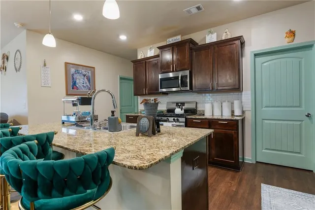a kitchen with sink refrigerator and microwave