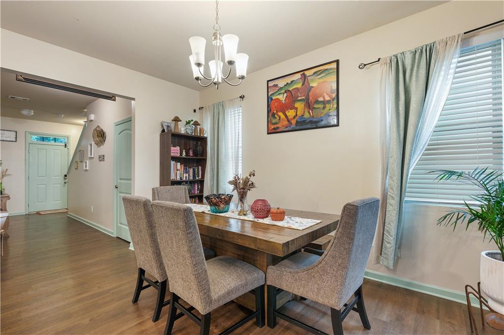 153 Centennial Ridge Drive Acworth, GA 30102 - Photo 15 of 38 a view of a dining room with furniture wooden floor and chandelier