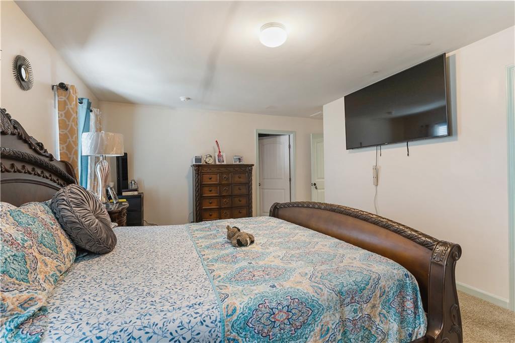 153 Centennial Ridge Drive Acworth, GA 30102 - Photo 24 of 38 a bedroom with a bed and a flat screen tv