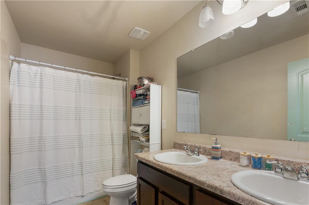 153 Centennial Ridge Drive Acworth, GA 30102 - Photo 30 of 38 a bathroom with a granite countertop sink a toilet and a mirror