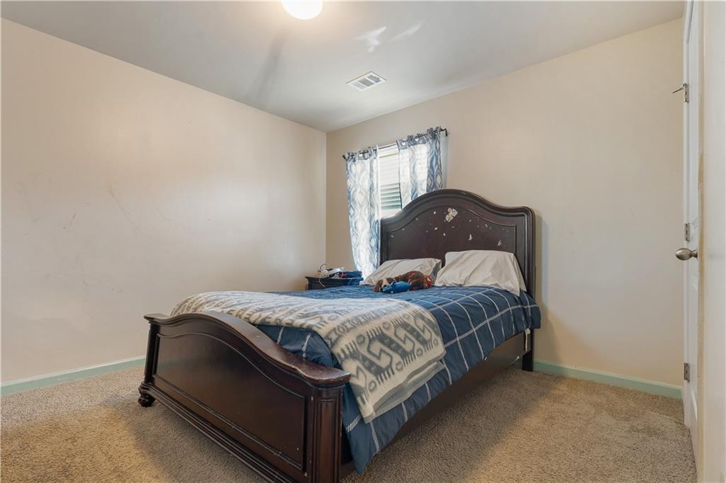 153 Centennial Ridge Drive Acworth, GA 30102 - Photo 33 of 38 a bedroom with a bed and window