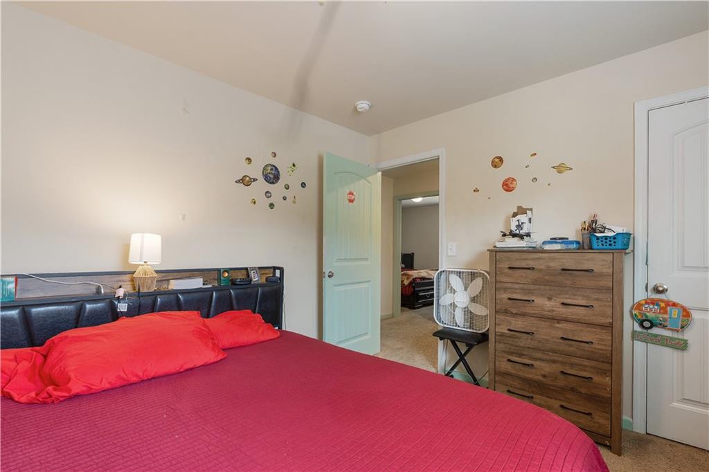 153 Centennial Ridge Drive Acworth, GA 30102 - Photo 37 of 38 a bedroom with a bed and a chandelier